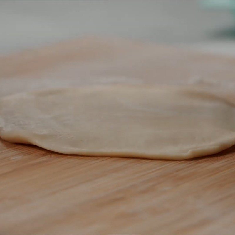 Step 5 Roll out the dough and wrap the mango custard filling Mango custard bun