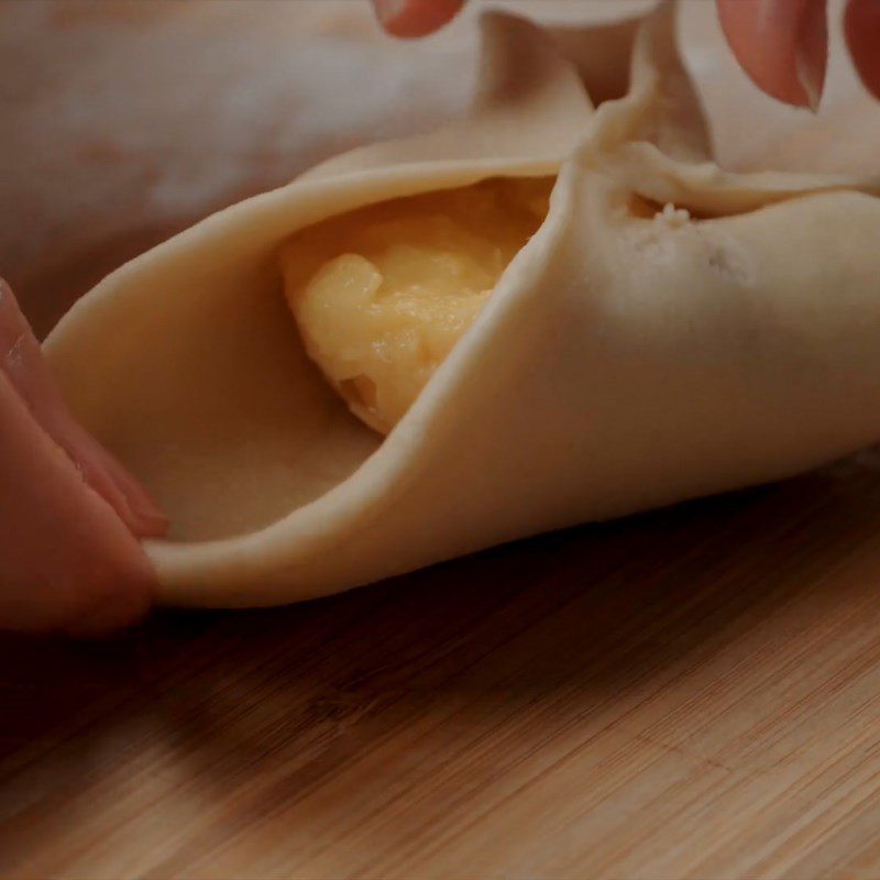 Step 5 Roll out the dough and wrap the mango custard filling Mango custard bun