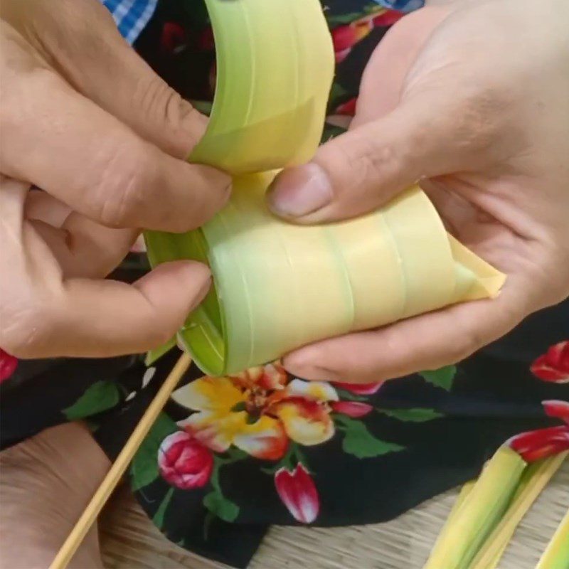 Step 2 Rolling coconut leaves to wrap the cake Coconut leaf cake Ben Tre