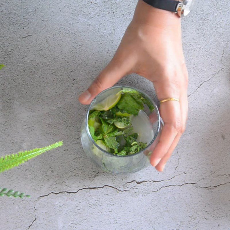 Step 2 Pound the lime and mint leaves for Fresh Mango Mojito