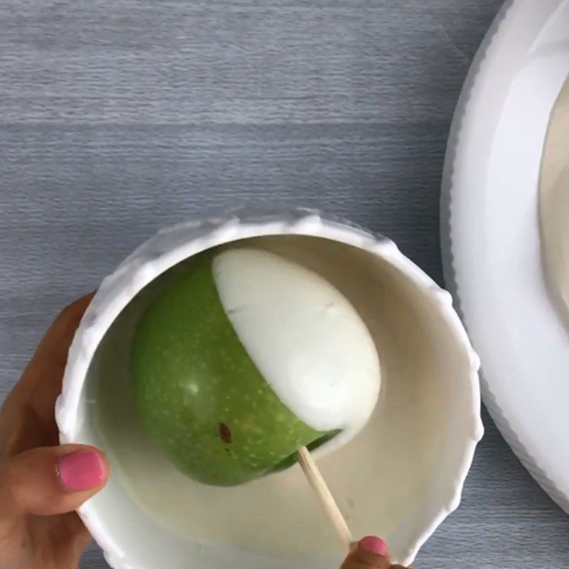 Step 2 Dipping the apples Chocolate-Covered Apple Candy in the shape of a unicorn