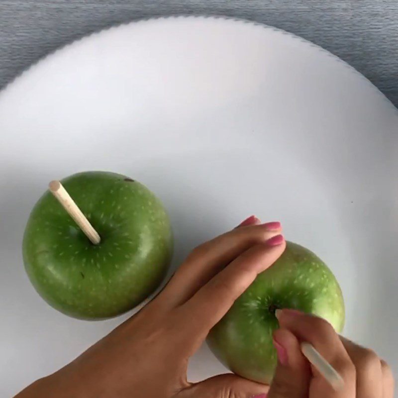 Step 2 Dipping the apples Chocolate-Covered Apple Candy in the shape of a unicorn