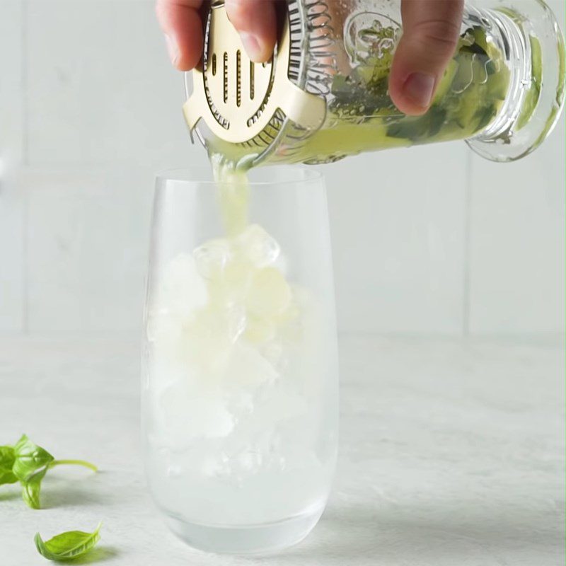 Step 2 Mix the cocktail and decorate Gin Tonic with cucumber and basil