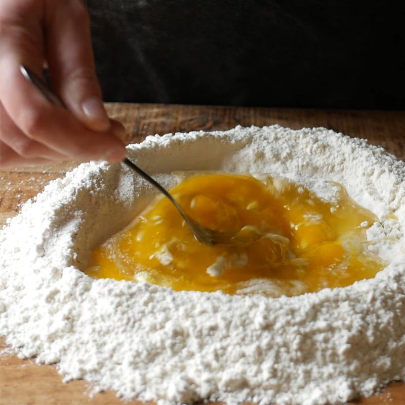 Step 1 Mixing the dough for cheese-filled ravioli with melted eggs