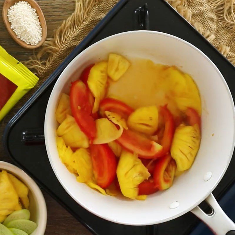 Step 3 Sauté tomatoes and pineapple Sour bitter melon soup with vegetarian dọc mùng