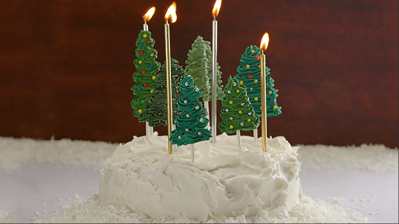 Decorating Christmas cake in the shape of a green pine forest