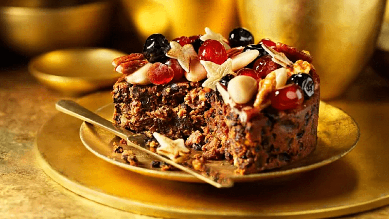 Decorating Christmas cake with nuts and dried fruits