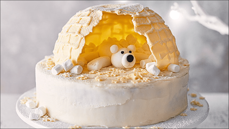 Decorating Christmas cake in a snow house shape