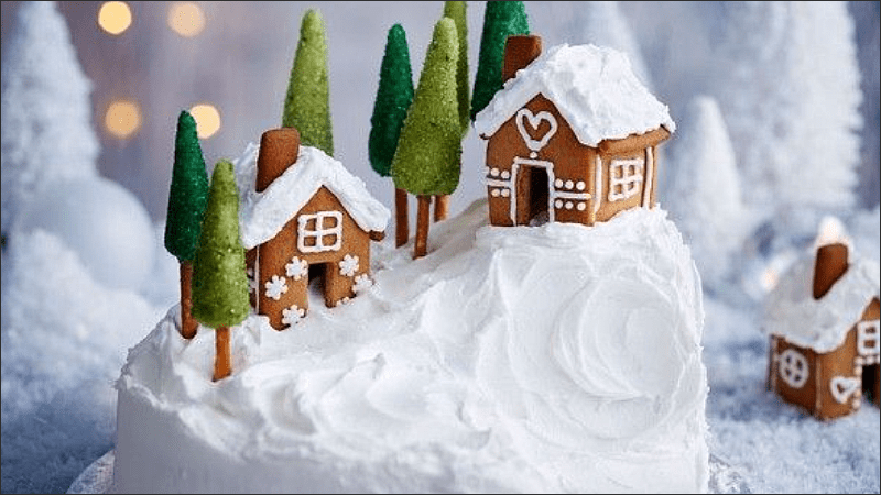 Decorating Christmas cake in the shape of a house on a mountain