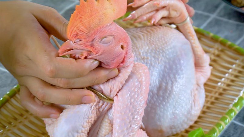 Tying neck and wings of praying chicken