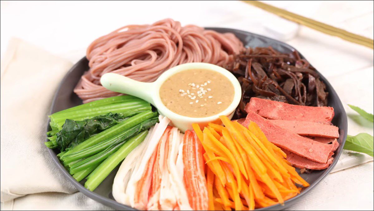 Brown rice noodles mixed with vegetables and crab sticks