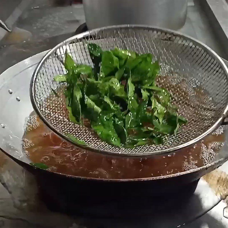 Step 4 Frying the mac mat leaves Pigeon roasted with five spices in oil