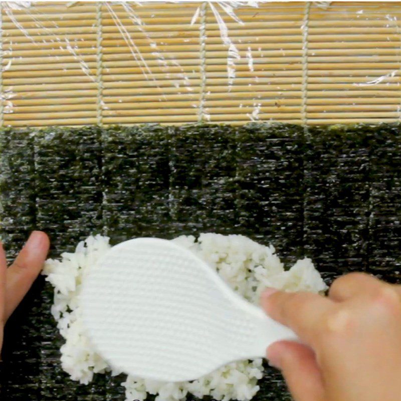 Step 3 Place rice on the seaweed leaf Sushi crab stick