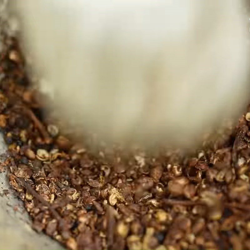 Step 1 Pounding the Marinade Mixture for the Fish Grilled Pa Pỉnh Tộp Using Charcoal Stove