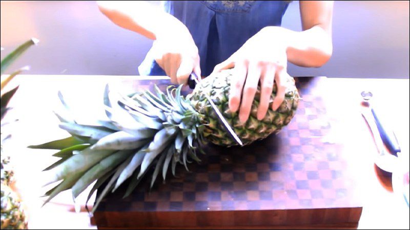 Cut the pineapple in half