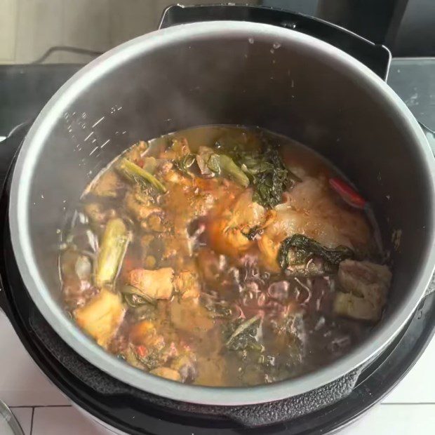 Step 4 Cooking Fish Carp braised with pickled mustard greens using an electric pressure cooker