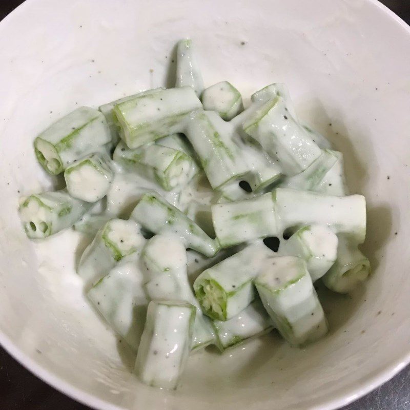 Step 3 Coating the okra with batter for crispy okra