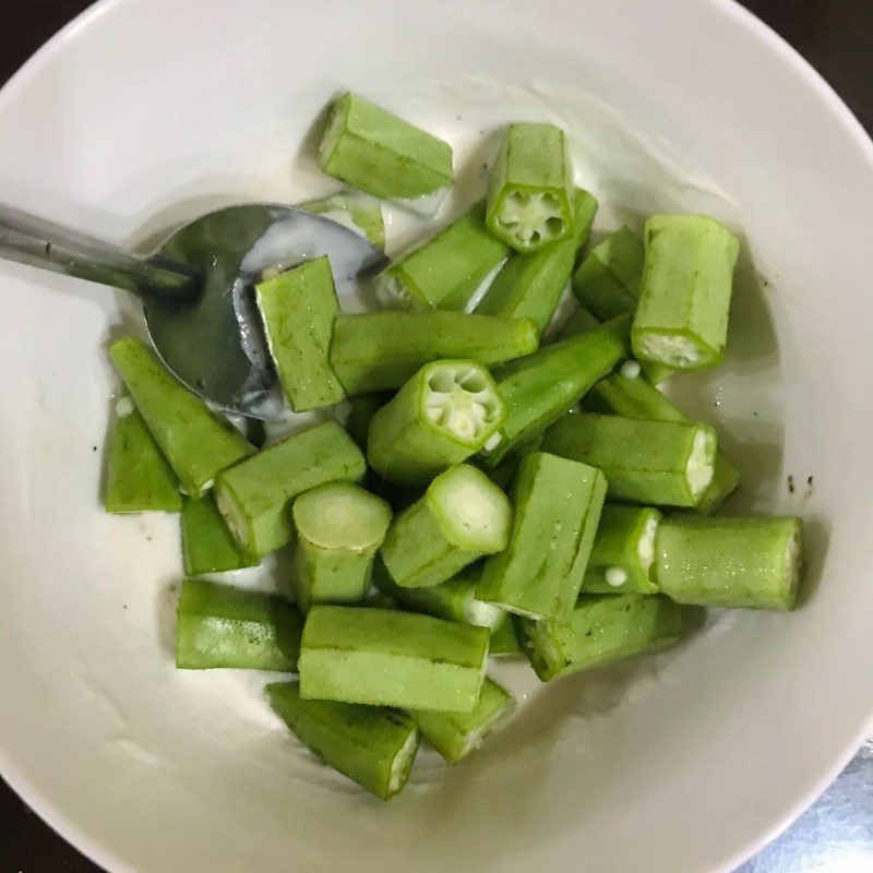 Step 3 Coating the okra with batter for crispy okra