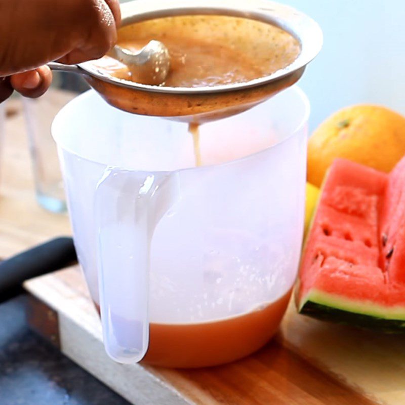 Step 3 Straining watermelon orange juice Watermelon orange juice with lemon and ginger