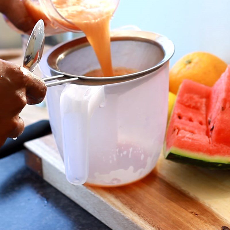 Step 3 Straining watermelon orange juice Watermelon orange juice with lemon and ginger