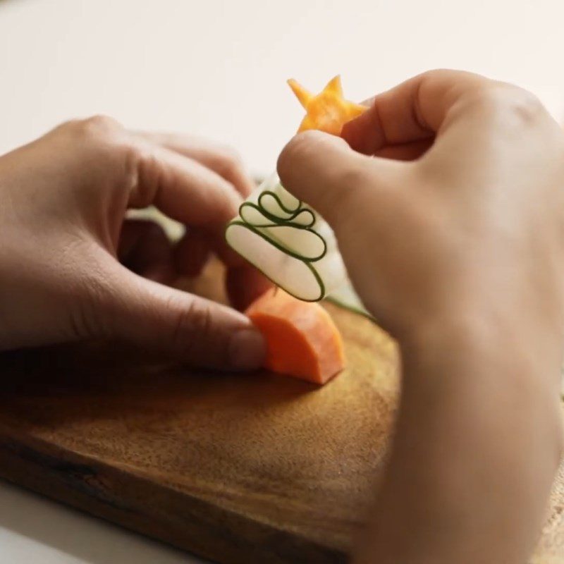 Step 3 Soak in water Fold the Christmas tree from cucumber, carrot