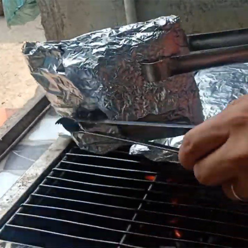 Step 4 Grilling meat Grilled pork wrapped in foil using charcoal stove