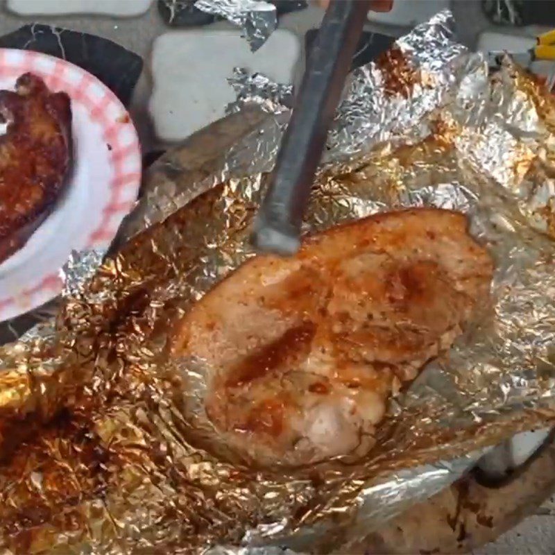 Step 4 Grilling meat Grilled pork wrapped in foil using charcoal stove