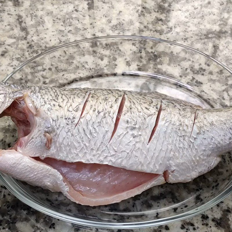 Step 1 Prepare and marinate the fish for steamed barramundi with shiitake mushrooms