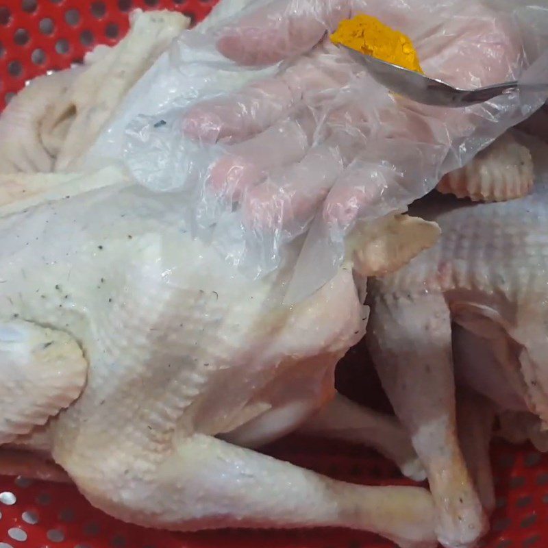 Step 2 Marinate chicken with turmeric powder Boil chicken using a rice cooker