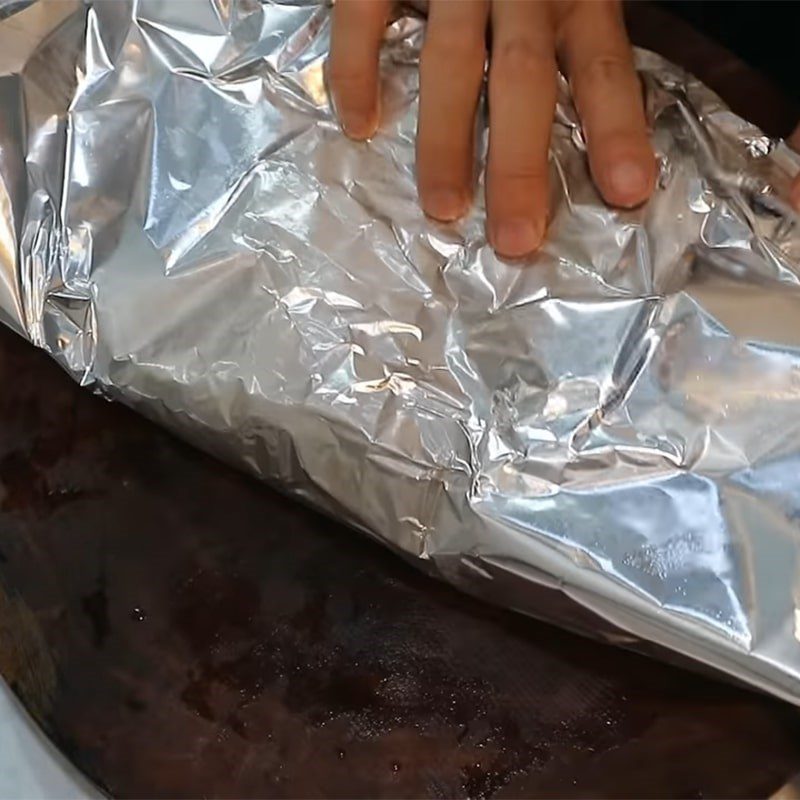 Step 2 Wrap the meat in banana leaves and aluminum foil Salted pork