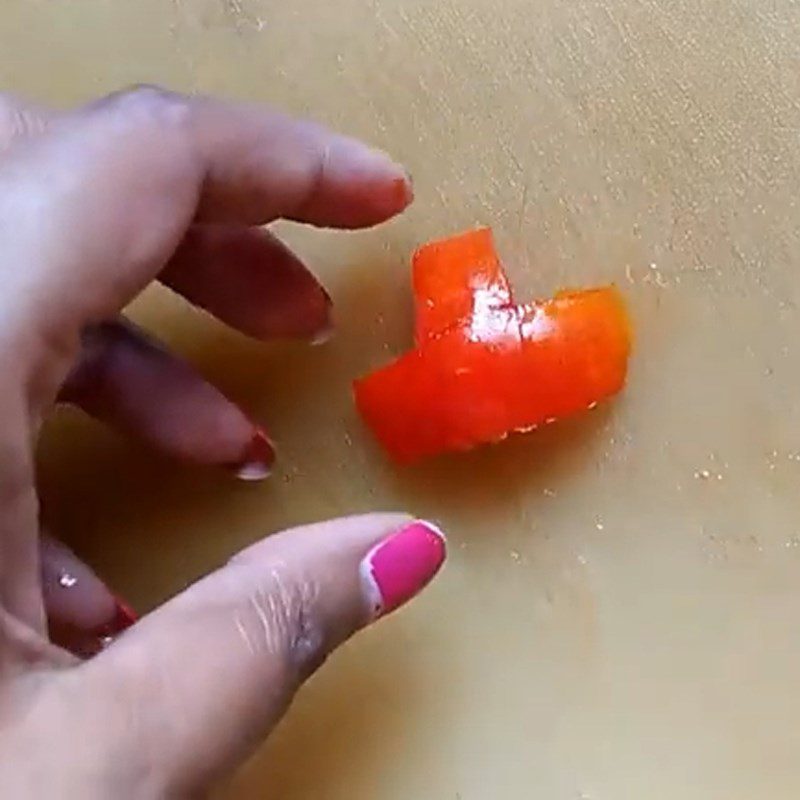 Step 1 Carve tomato for snowman from rice