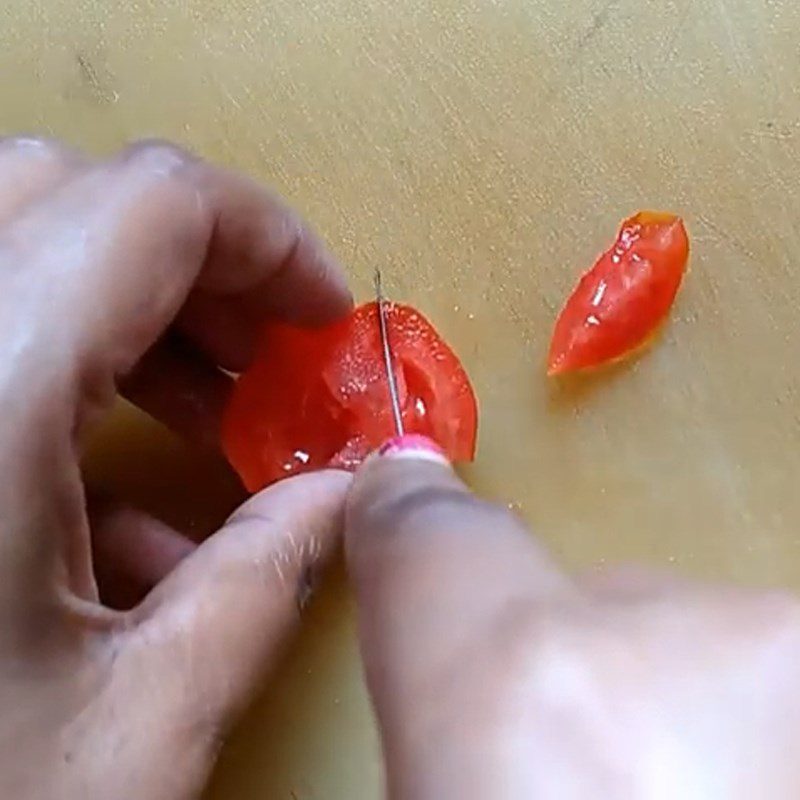 Step 1 Carve tomato for snowman from rice