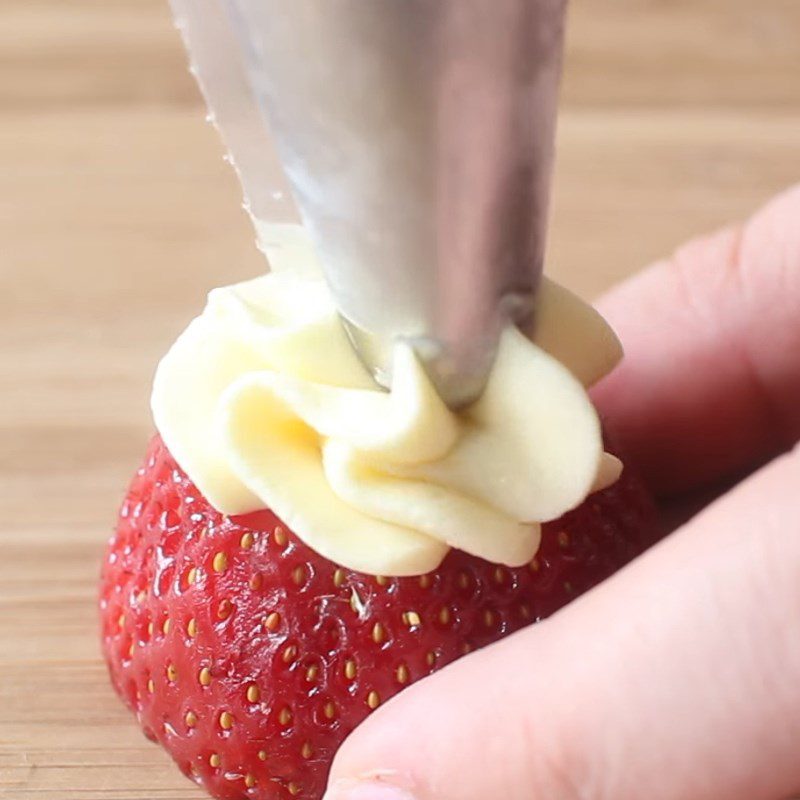 Step 3 Decorating Snowman made from strawberries and whipped cream