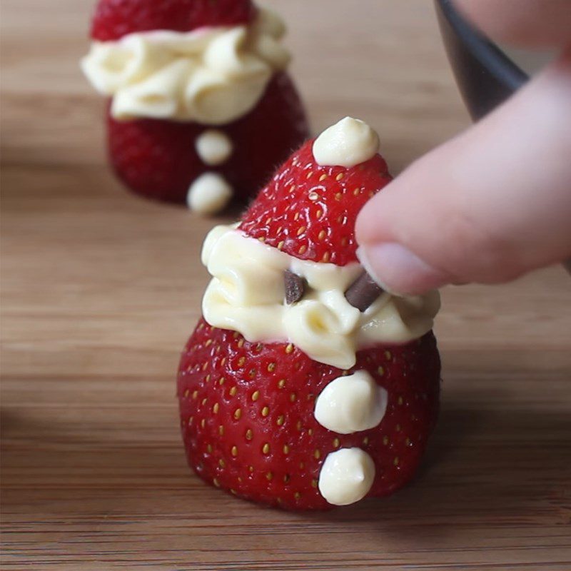 Step 3 Decorating Snowman made from strawberries and whipped cream