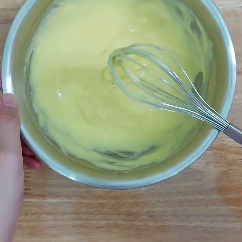 Step 2 Mix the egg yolk mixture with flour for Raisin Swiss Roll Cake