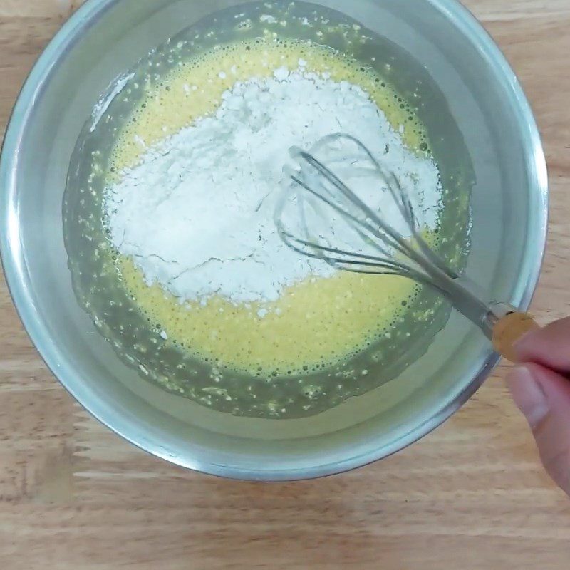 Step 2 Mix the egg yolk mixture with flour for Raisin Swiss Roll Cake