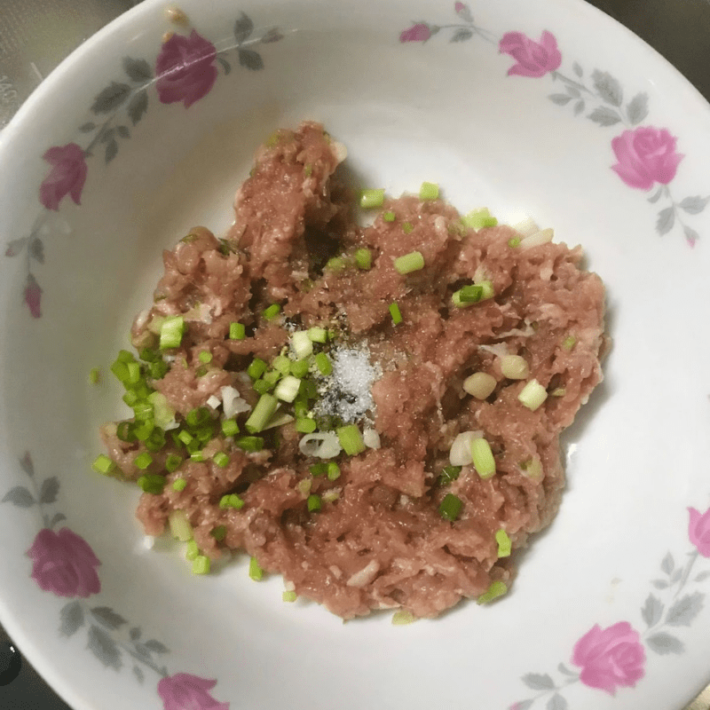 Step 2 Marinate the meat filling and stuff it into the gourd for Stuffed Bottle Gourd Soup