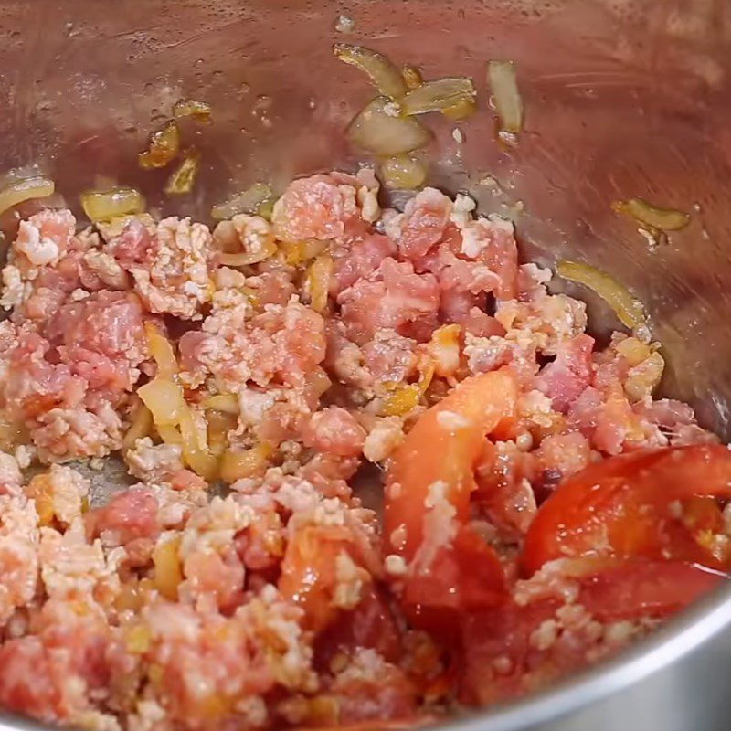 Step 2 Sauté tomatoes with minced pork for Banana Flower Soup