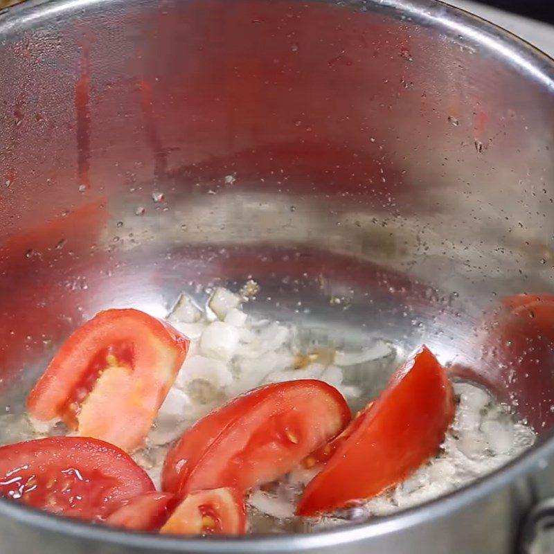 Step 2 Sauté tomatoes with minced pork for Banana Flower Soup