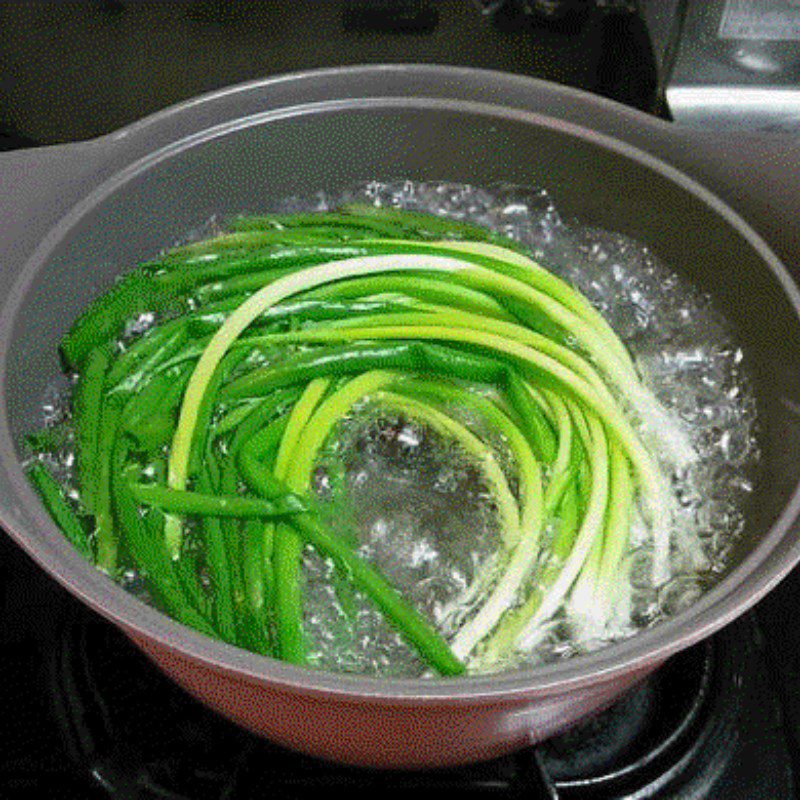 Step 2 Boil the green onions for Octopus Salad with Green Onions