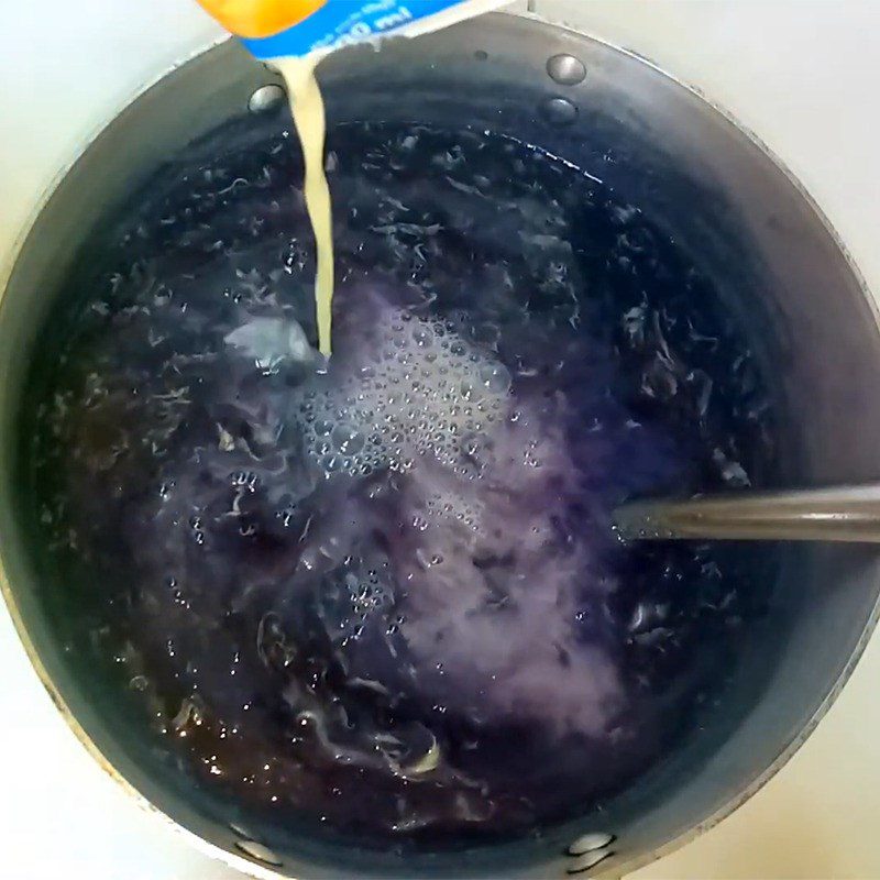 Step 5 Cooking porridge with eggs and milk Purple sweet potato egg porridge
