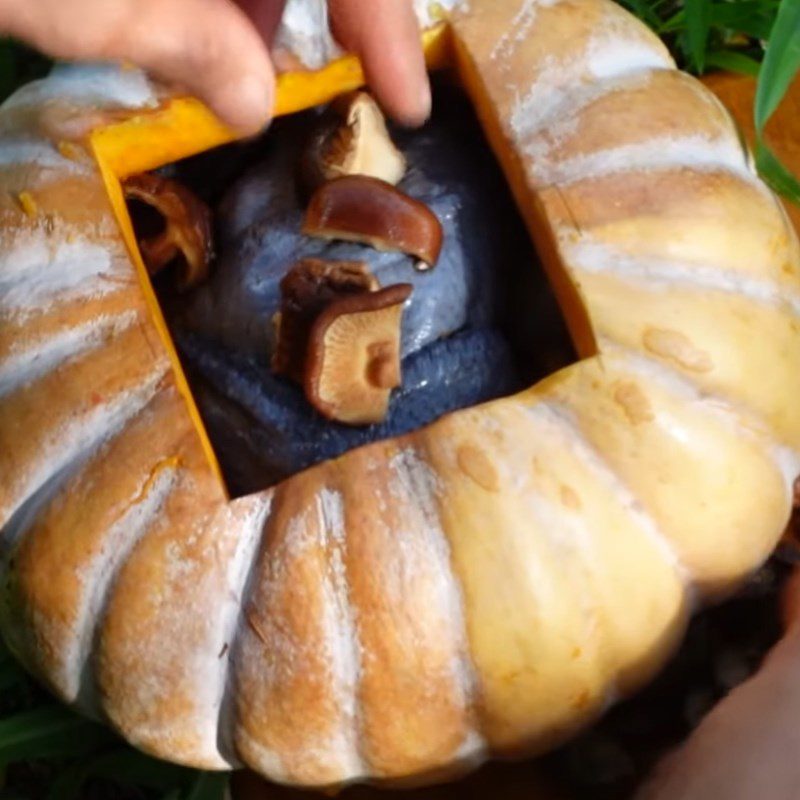 Step 3 Stuff the chicken into the pumpkin Black chicken wrapped in foil stuffed with pumpkin