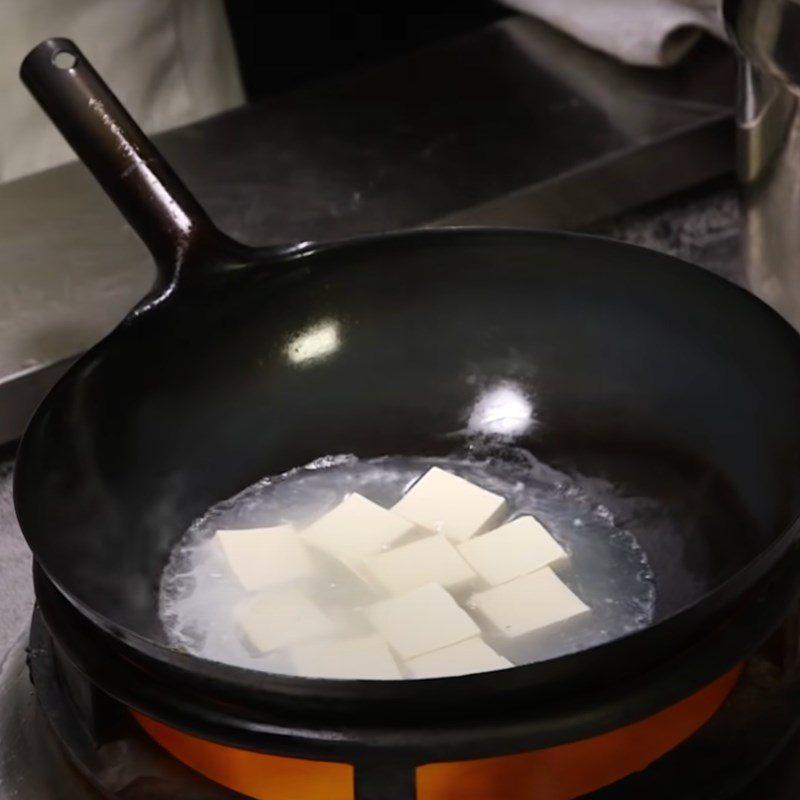 Step 3 Preparing and boiling tofu Crispy fried barramundi with soy sauce