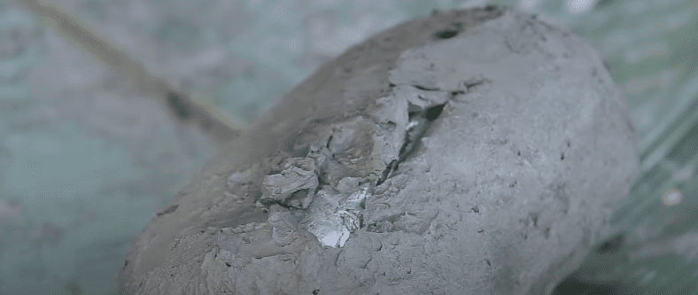 Step 4 Wrapping chicken with clay for baking in foil