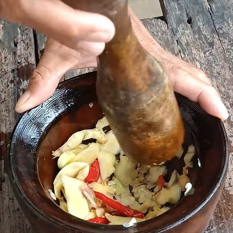 Step 2 Pound the marinating spices Dried catfish marinated with ginger and chili