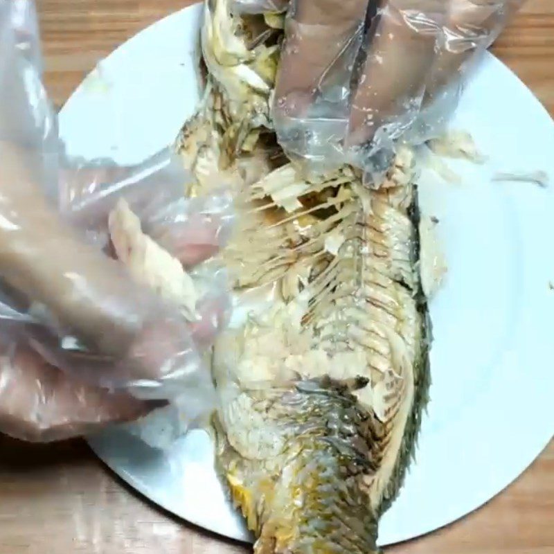 Step 2 Boil and separate the carp meat for Carp congee with lotus seeds