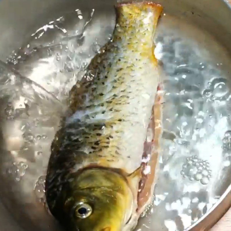 Step 2 Boil and separate the carp meat for Carp congee with lotus seeds