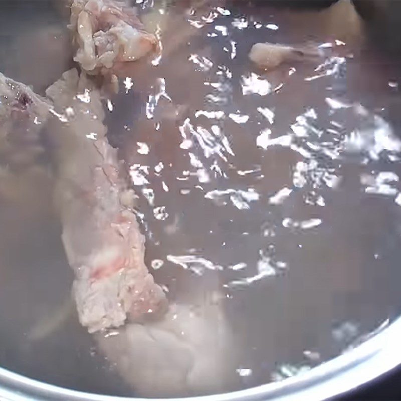 Step 1 Prepare and simmer the bones for Curry Fish Ball Noodles