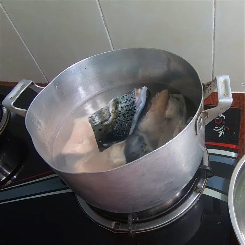 Step 1 Prepare and marinate shrimp and fish for Sour Salmon Head Soup with Shrimp