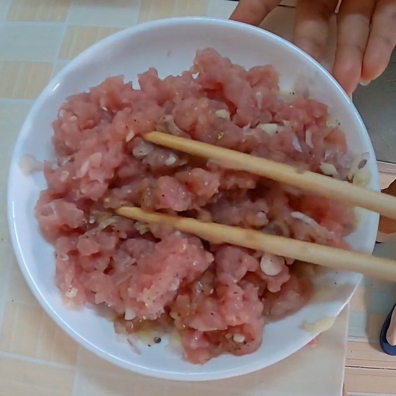 Step 2 Marinating the meat for Duck Egg Porridge